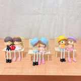 TM0024 Cute Couple Dolls Sitting on Bench with Dangling Legs - Resin Showpiece for Home Decor & Gifting