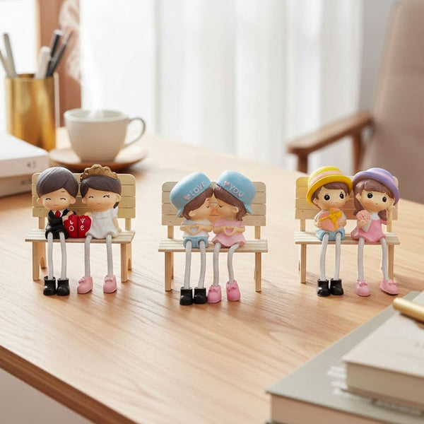 TM0024 Cute Couple Dolls Sitting on Bench with Dangling Legs - Resin Showpiece for Home Decor & Gifting